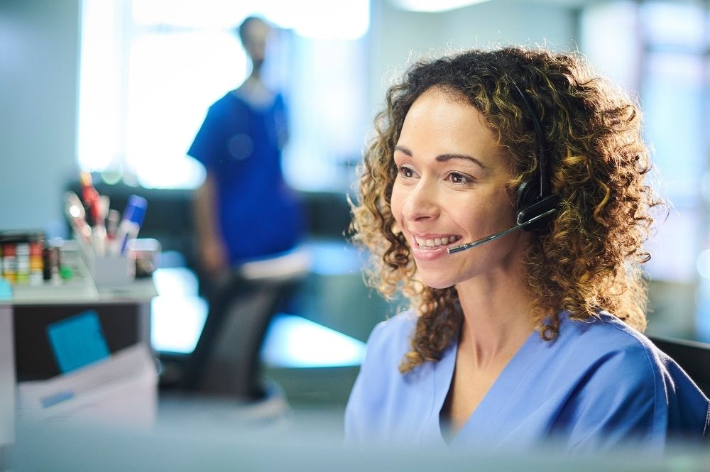 A woman nurse navigator on the phone with a Rare and Orphan Disease Patient, talking through a Nurse Educator Program