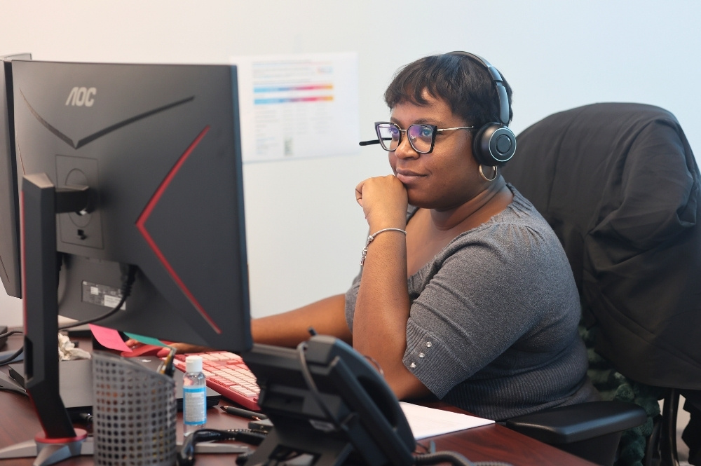 Registered nurse navigator providing patient support to improve medication adherence through digital tools and compassionate care.