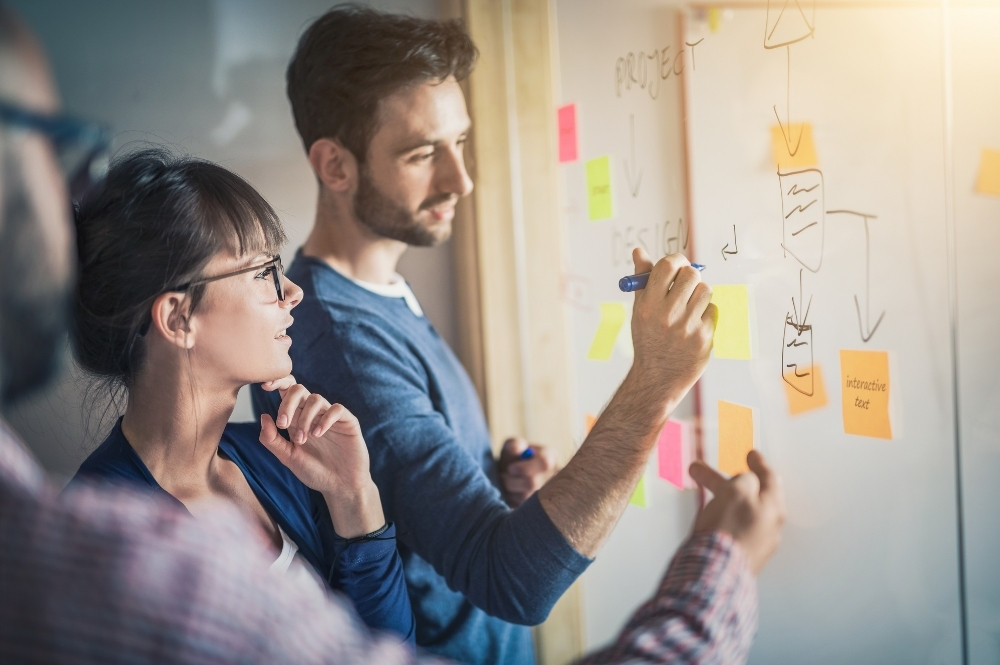 Team brainstorming patient recruitment workflow with AI technology in clinical trials