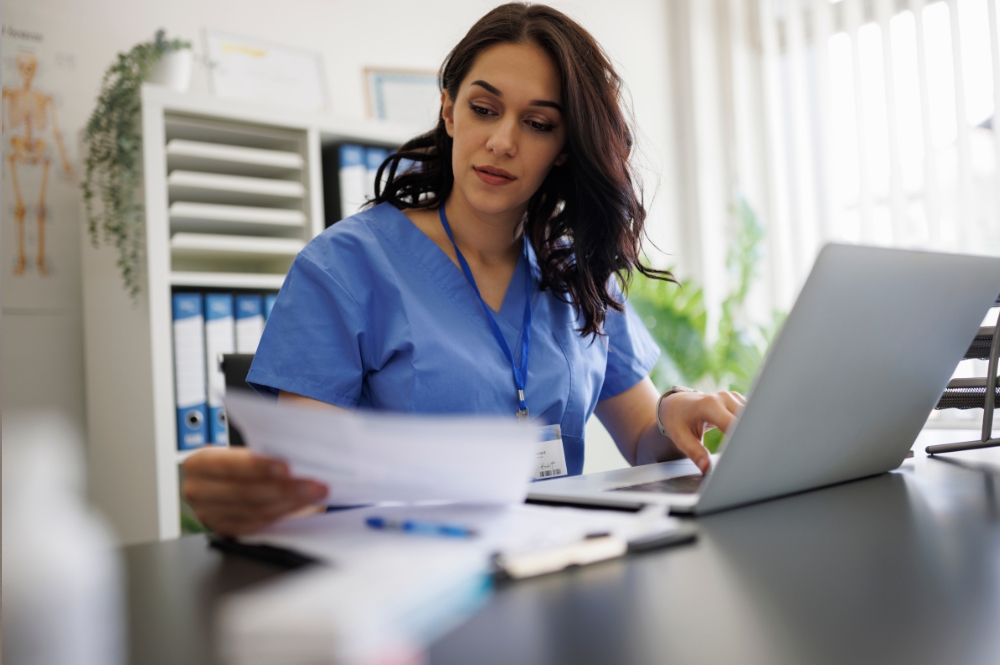 Clinical trial referral management coordinator reviewing patient documents and scheduling support tasks