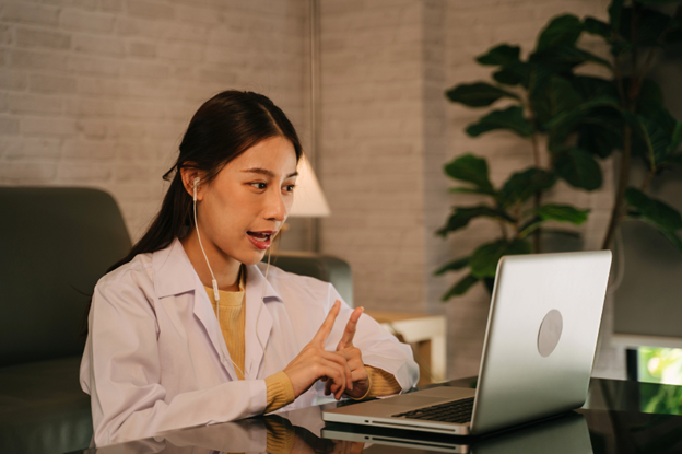 Female physician at her office laptop, exploring how patient assistance programs function and their relevance.