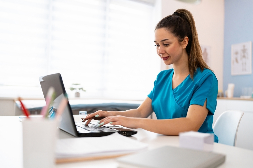 Nurse using a laptop to support complex case management and access workflows