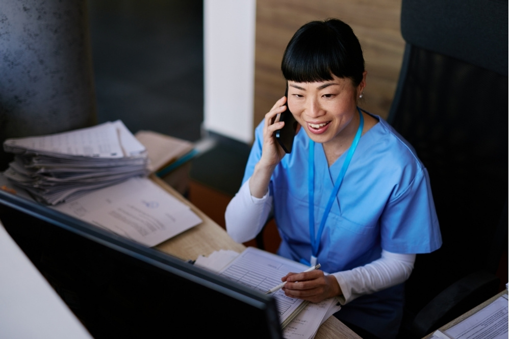 Nurse calling a clinical trial participant for follow-up outreach