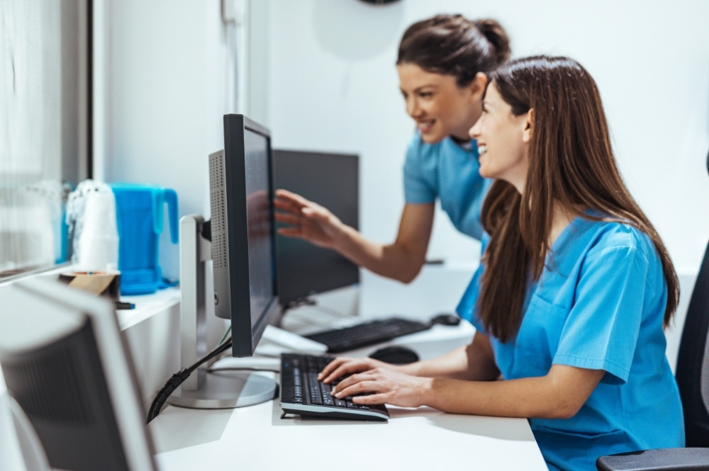Healthcare team using computers to reduce clinical trial operational bottlenecks