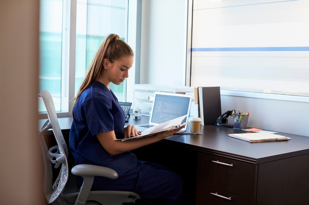 Healthcare professional reviewing records to improve clinical trial referral quality