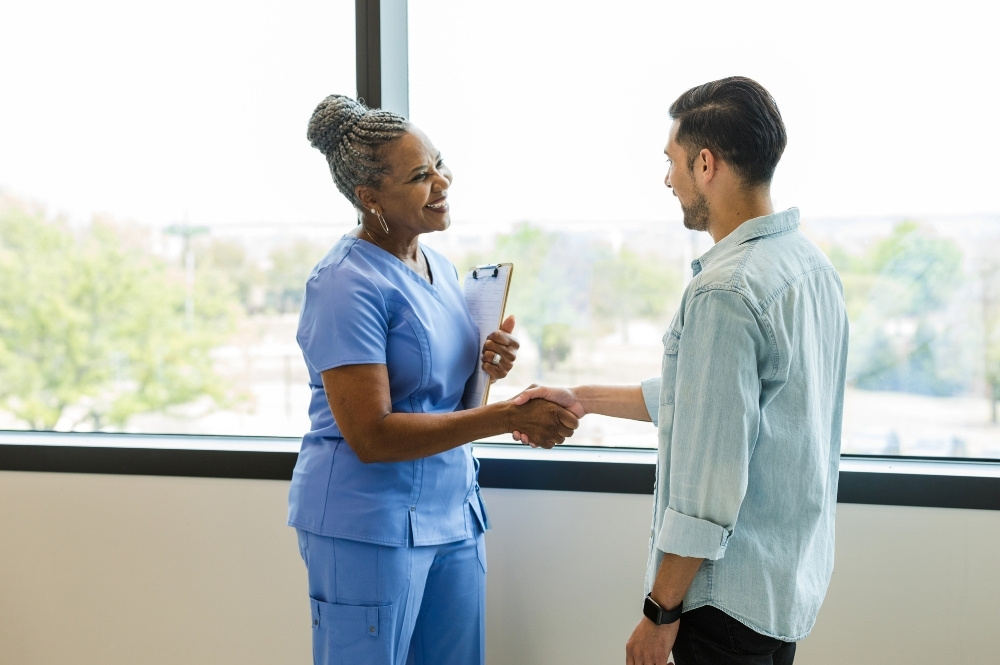 Healthcare professional greeting a patient for community-based clinical trials support